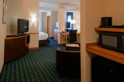 a hotel room with a bed and a television at Fairfield Inn & Suites Kennett Square in Kennett Square