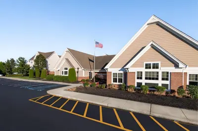 a house with an american flag on a street at Residence Inn Mt. Laurel at Bishop's Gate in Mount Laurel