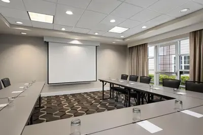 a large conference room with a white screen and a board at Residence Inn Mt. Laurel at Bishop's Gate in Mount Laurel