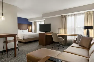 a hotel room with a couch and a desk and a bed at Residence Inn by Marriott Philadelphia West Chester/Exton in Exton