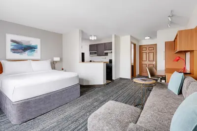 a hotel room with a bed and a living room at TownePlace Suites Philadelphia Horsham in Horsham