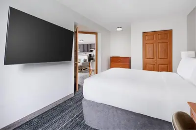a hotel room with a bed and a flat screen tv at TownePlace Suites Philadelphia Horsham in Horsham