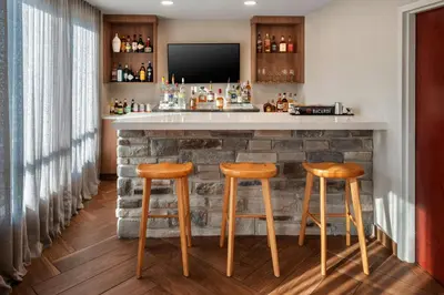 a bar with two stools and a tv at Fairfield Inn & Suites by Marriott Somerset in Somerset