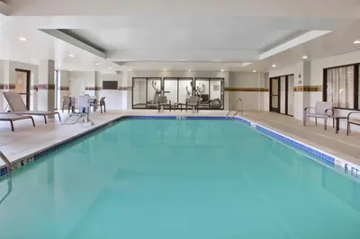 a large pool with blue water in a hotel room at Courtyard by Marriott Somerset in Somerset
