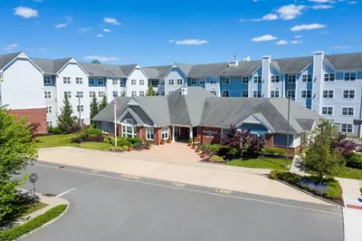 a large apartment building with a street in front at Residence Inn by Marriott Princeton at Carnegie Center in Princeton