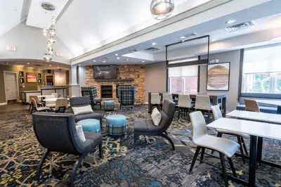 a waiting room with tables and chairs at Residence Inn by Marriott Princeton at Carnegie Center in Princeton