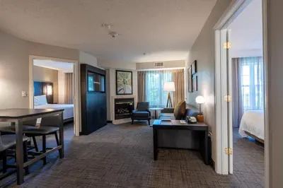 a hotel room with a bed and a living room at Residence Inn by Marriott Princeton at Carnegie Center in Princeton
