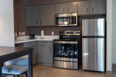 a kitchen with a stainless steel refrigerator and a microwave at Residence Inn by Marriott Princeton at Carnegie Center in Princeton