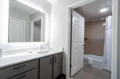 a bathroom with a sink and a mirror and a shower at Residence Inn by Marriott Princeton at Carnegie Center in Princeton
