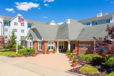 a house with an american flag in front of it at Residence Inn by Marriott Princeton at Carnegie Center in Princeton