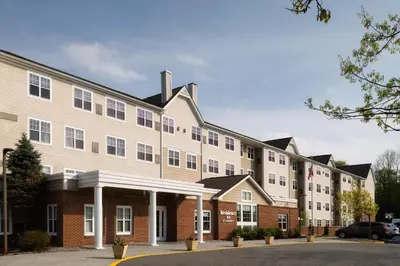 a large building with a car parked in front of it at Residence Inn Mount Olive At International Trade Center in Stanhope