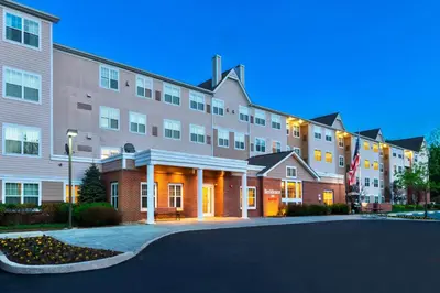 a large apartment building with a street in front of it at Residence Inn Mount Olive At International Trade Center in Stanhope