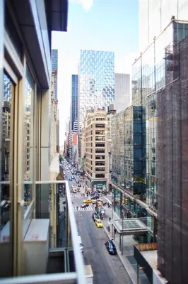 a view from a window of a city street with cars at The Gotham Hotel in New York