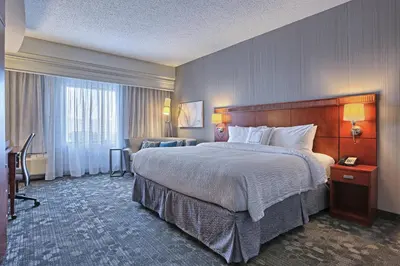a hotel room with a large bed and a window at Courtyard by Marriott Harrisburg West/Mechanicsburg in Mechanicsburg