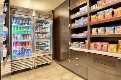 a grocery store aisle with an open refrigerator at Courtyard by Marriott Harrisburg West/Mechanicsburg in Mechanicsburg