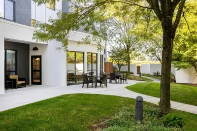 a courtyard with a table and chairs in a building at Courtyard by Marriott Harrisburg West/Mechanicsburg in Mechanicsburg