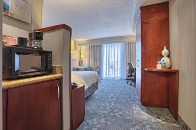 a hotel room with a bed and a microwave at Courtyard by Marriott Harrisburg West/Mechanicsburg in Mechanicsburg