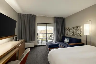 a hotel room with a bed and a couch at Courtyard Wilmington Brandywine in Wilmington