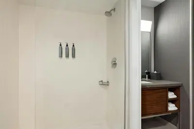 a bathroom with a shower and a sink at Courtyard Wilmington Brandywine in Wilmington