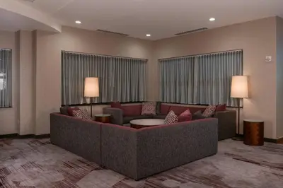 a living room with a couch and a table at Courtyard by Marriott Newark-University of Delaware in Newark