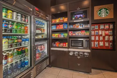 a refrigerator filled with lots of drinks and a microwave at Courtyard by Marriott Newark-University of Delaware in Newark