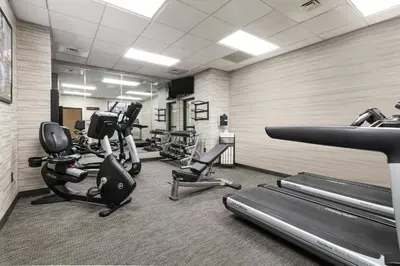 a gym with several treadmills and cardio machines at Courtyard by Marriott Newark-University of Delaware in Newark