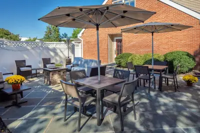 a patio with tables and chairs and umbrellas at Residence Inn Cherry Hill Philadelphia in Cherry Hill