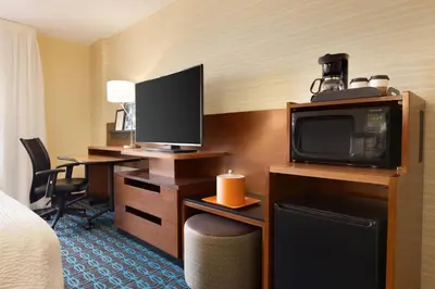 a hotel room with a bed and a tv and a desk at Fairfield Inn Philadelphia Valley Forge/King of Prussia in King of Prussia
