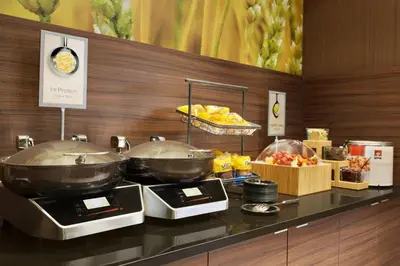 a kitchen with two woks on a counter with food at Fairfield Inn Philadelphia Valley Forge/King of Prussia in King of Prussia