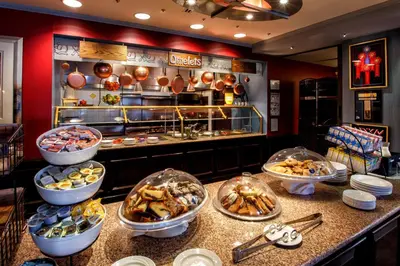 a buffet line with many different types of food at Hilton Garden Inn New York/Staten Island in Staten Island