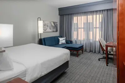 a hotel room with a bed and a chair at Courtyard Reading Wyomissing in Reading