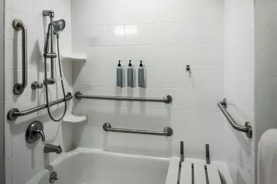 a bathroom with a bath tub with two bottles at Courtyard Reading Wyomissing in Reading