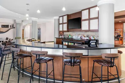 a bar at a hotel with stools at Courtyard Reading Wyomissing in Reading
