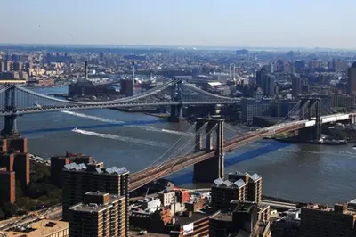 a large bridge over a river in a city at M Social Hotel New York Downtown in New York