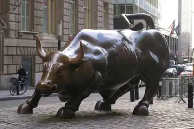 a statue of a bull on a city street at M Social Hotel New York Downtown in New York