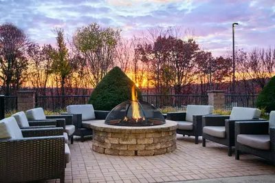 a fire pit in a patio with lounge chairs and a fire at Courtyard by Marriott Scranton Montage Mountain in Moosic