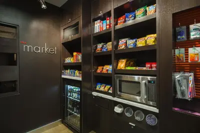 a kitchen with a microwave and some shelves with food at Courtyard by Marriott Scranton Montage Mountain in Moosic