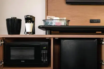 a microwave sitting on a shelf next to a counter at Fairfield Inn by Marriott Scranton in Scranton