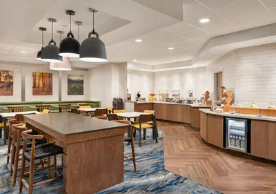 a restaurant with tables and chairs and a cafeteria at Fairfield Inn by Marriott Scranton in Scranton
