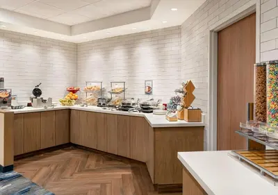 a large kitchen with a counter with food on it at Fairfield Inn by Marriott Scranton in Scranton