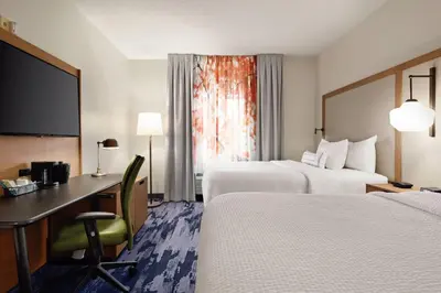 a hotel room with two beds and a desk at Fairfield Inn by Marriott Scranton in Scranton