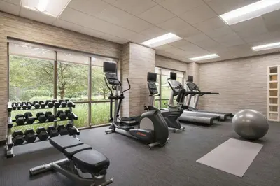 a gym with treadmills and elliptical machines at Courtyard by Marriott Middletown Goshen in Middletown