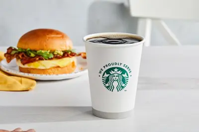 a cup of coffee and a sandwich on a table at Courtyard by Marriott Ewing Princeton in Ewing