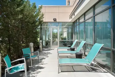 a row of chairs sitting outside of a building at SpringHill Suites Ewing Township Princeton South in Ewing