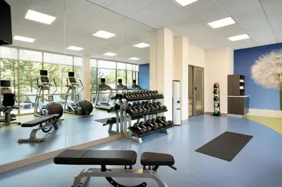a gym with several treadmills and exercise machines at SpringHill Suites Ewing Township Princeton South in Ewing