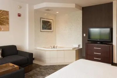 a living room with a tub and a tv at SpringHill Suites Quakertown Pennsylvania in Quakertown