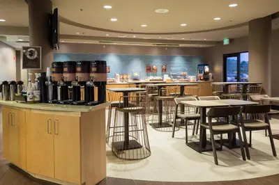 a bar with tables and stools in a restaurant at SpringHill Suites Quakertown Pennsylvania in Quakertown