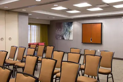 a room with a bunch of chairs and a podium at SpringHill Suites Quakertown Pennsylvania in Quakertown