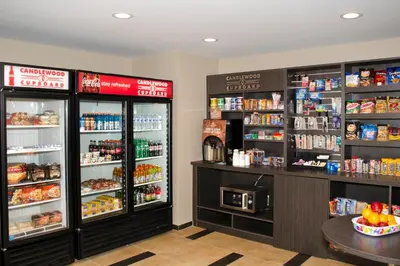 a store with two refrigerators and a counter with food at Candlewood Suites - Lancaster West by IHG in Lancaster