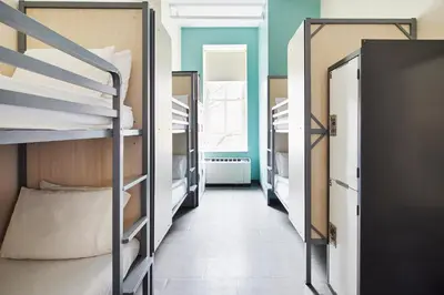 a corridor of a dorm room with bunk beds at HI New York City Hostel in New York
